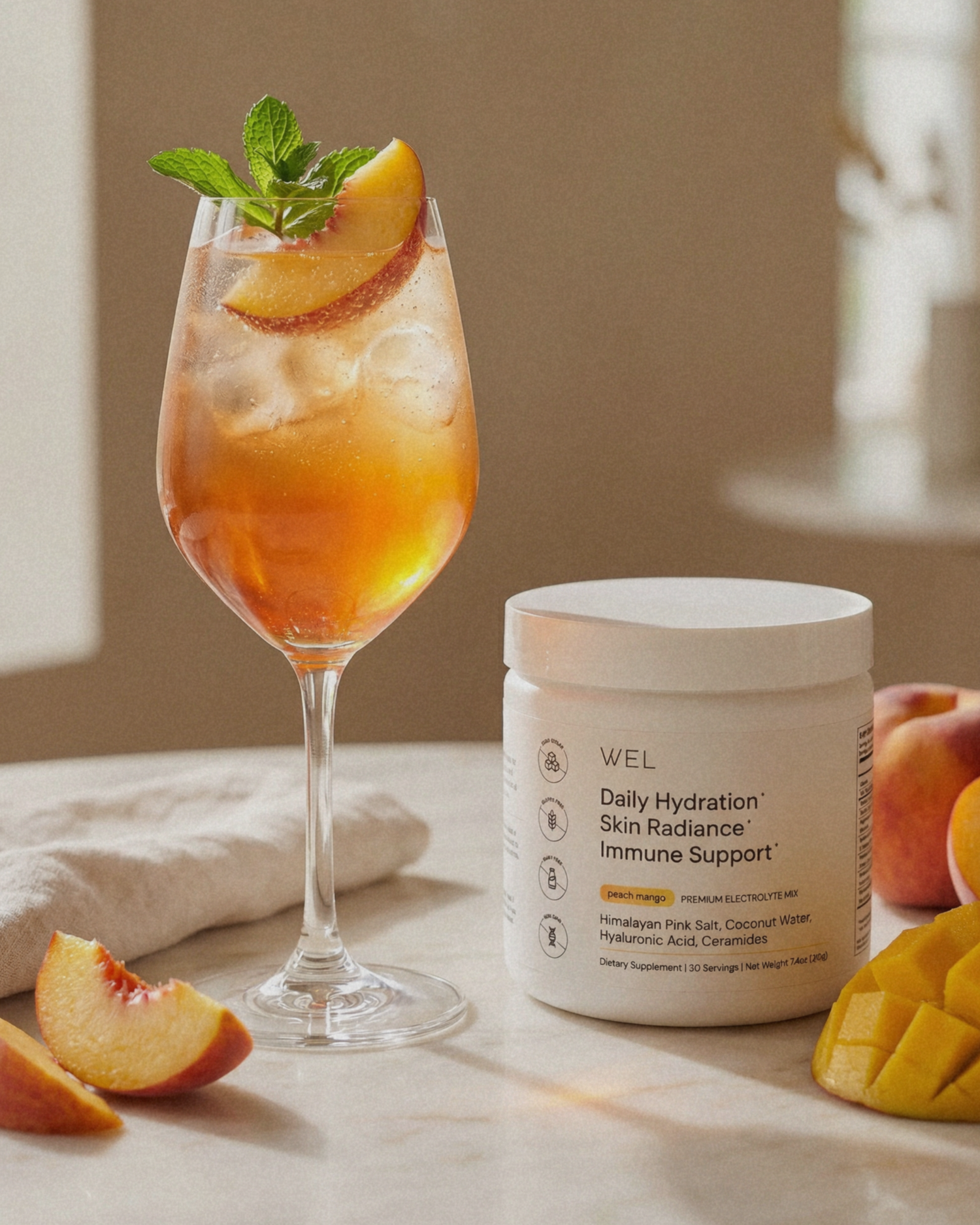 Garnished glass of peach iced tea spritz made with WEL premium electrolytes.