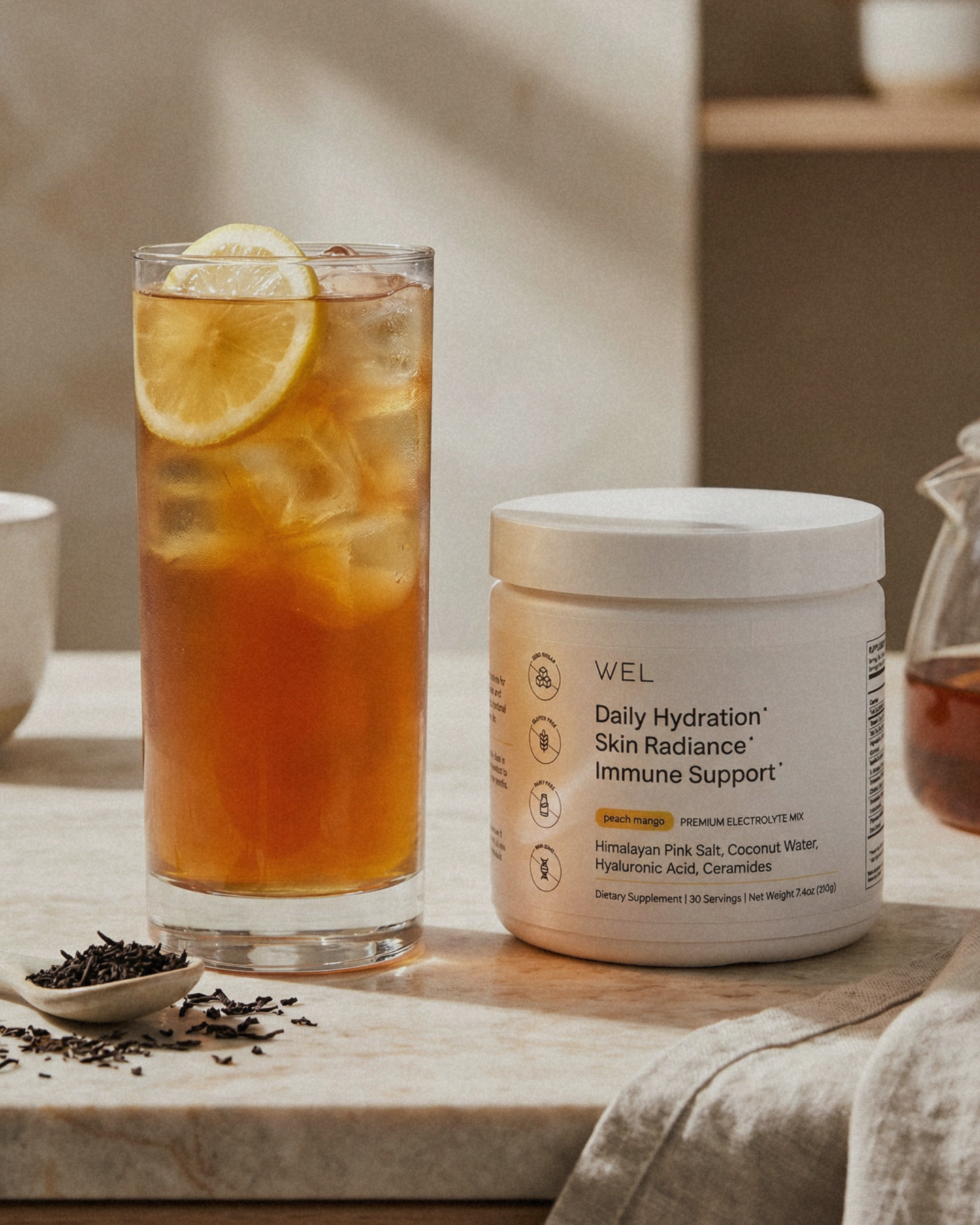 Glass of iced tea with lemon slices made with WEL premium electrolytes.